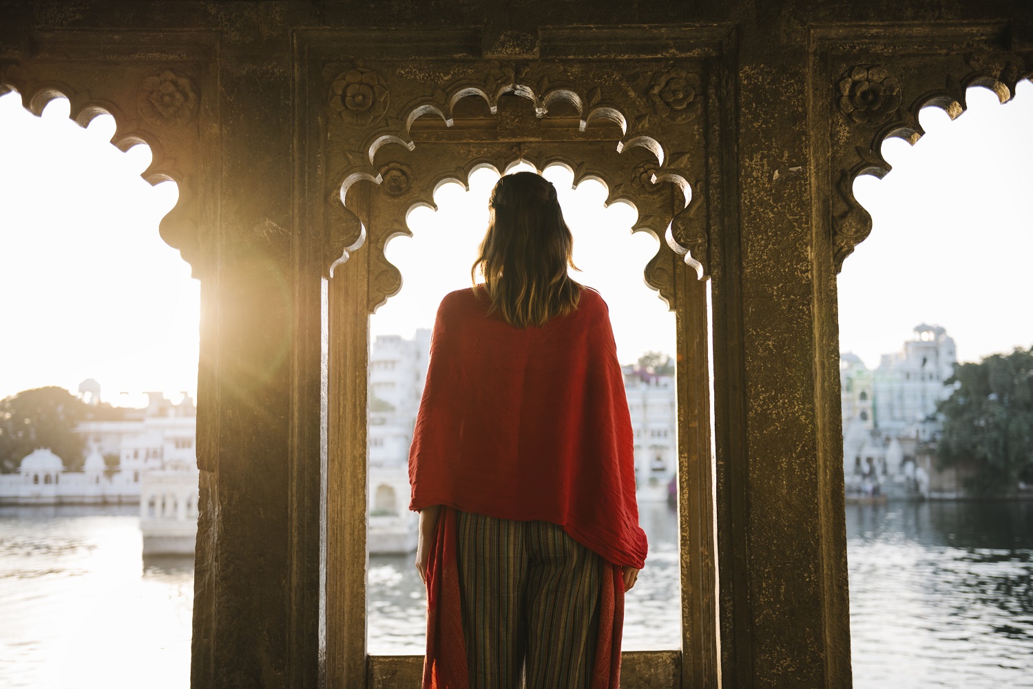 Western woman standing on a cultural architecture in Udaipur, India