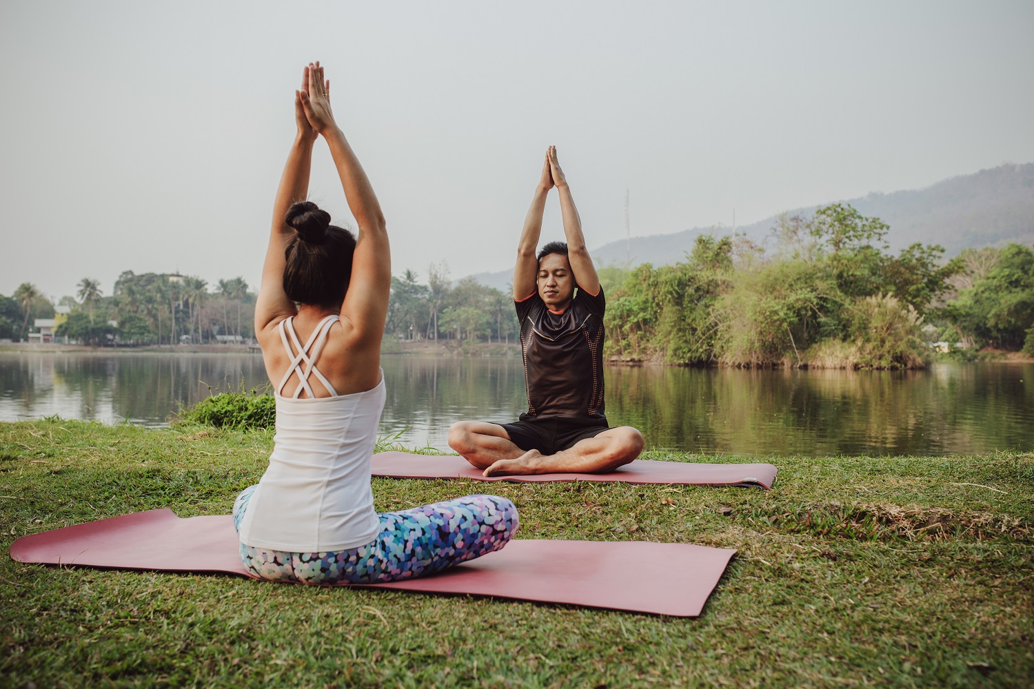 yoga-partners-sitting-with-hands-up